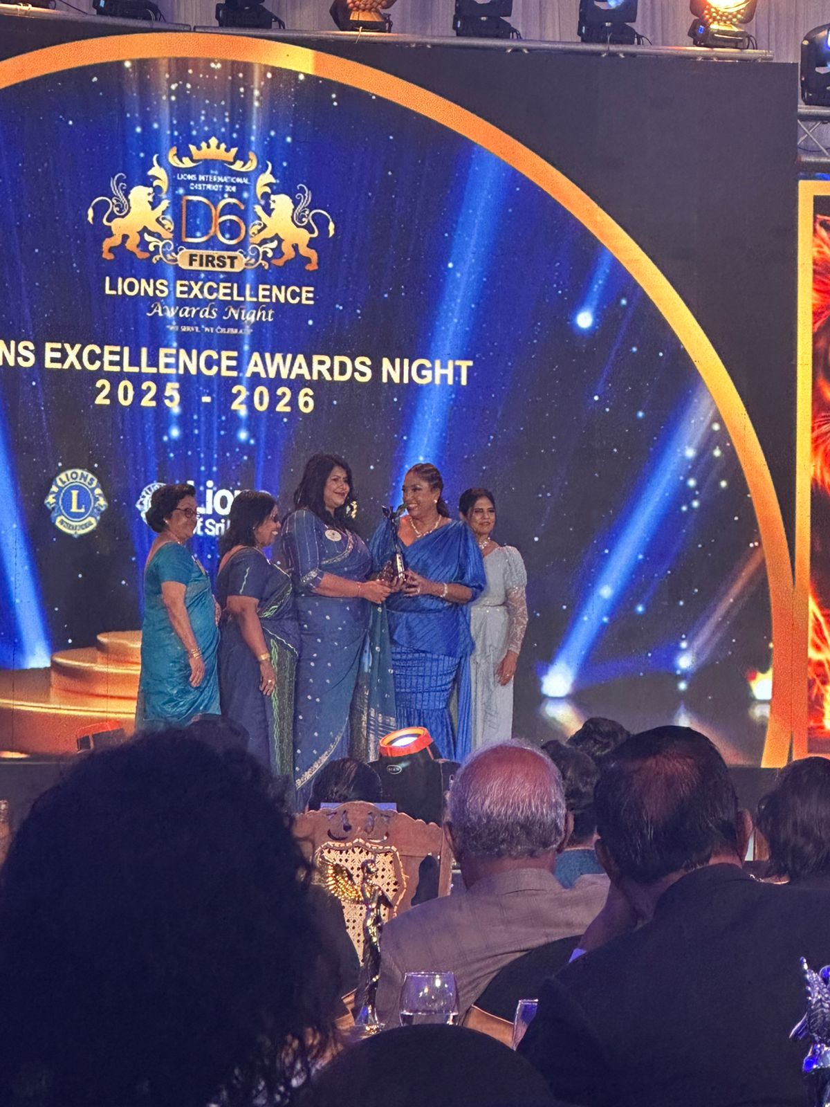 Lion Thushari Dissanayake PMAF receiving an award on stage at the Lions District 306D6 ceremony